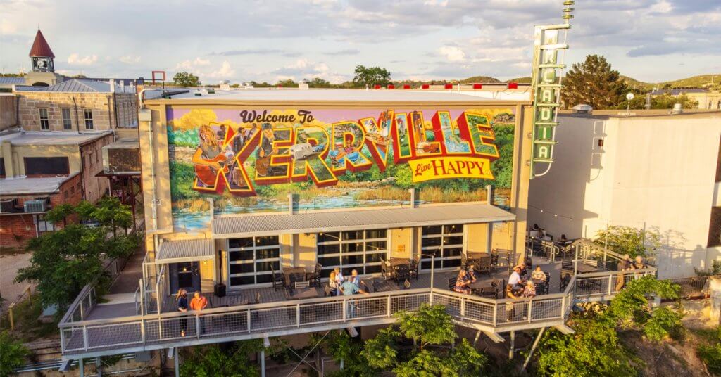 A vibrant mural welcomes visitors to Kerrville with colorful lettering and scenic imagery